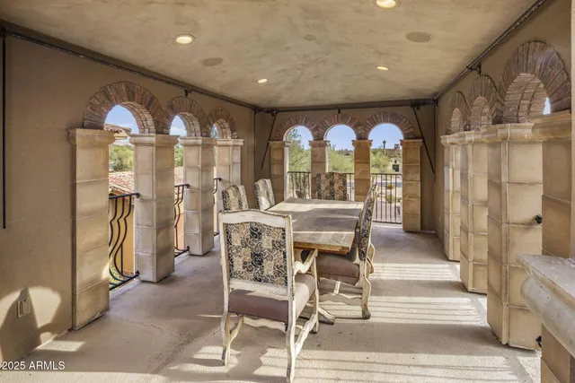 a patio with couches and a potted plant on a table