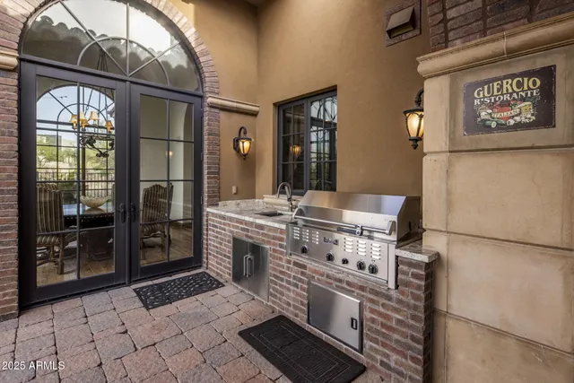 a kitchen with stainless steel appliances granite countertop a refrigerator a sink and a stove