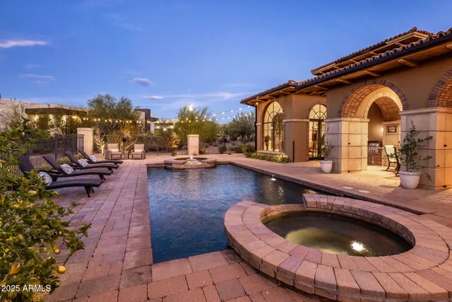 a view of a swimming pool with lawn chairs and a yard