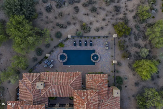 a view of a hallway with furniture and a mirror