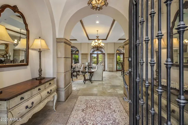 a view of hall way with furniture and mirror