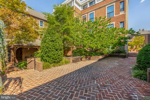 a view of a patio with table and chairs and potted plants