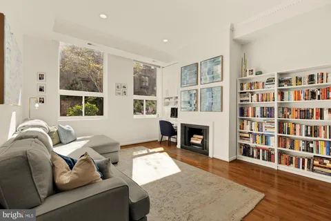 a living room with furniture window and a bookshelf