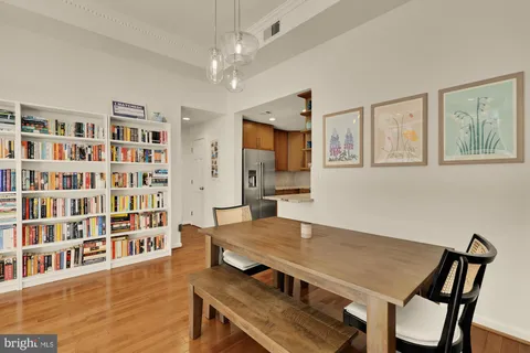 a view of a dining room with furniture and a bookshelf