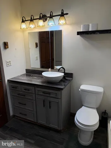 a bathroom with a toilet sink and mirror