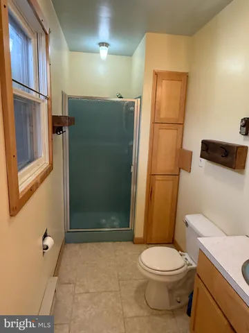 a bathroom with a toilet and a shower