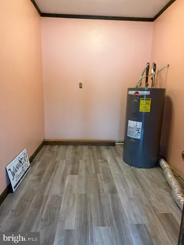 a view of a room with wooden floor and cabinet