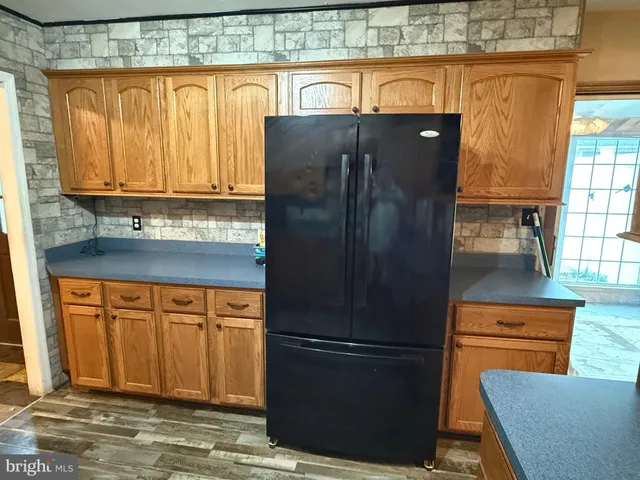 a kitchen with stainless steel appliances granite countertop a refrigerator and a stove