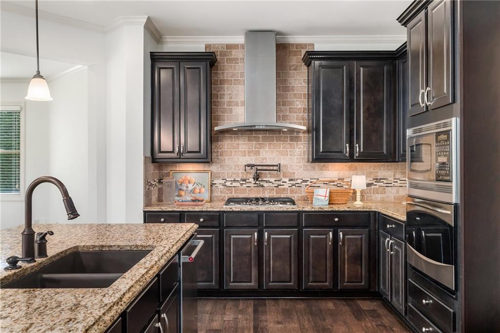 6660 Tulip Plantation Road Alpharetta, GA 30004 - Photo 14 of 68 a kitchen with granite countertop a sink and a stove