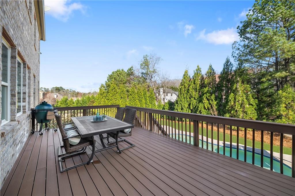 6660 Tulip Plantation Road Alpharetta, GA 30004 - Photo 18 of 68 a view of a balcony with wooden floor and outdoor seating