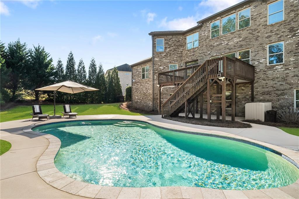 6660 Tulip Plantation Road Alpharetta, GA 30004 - Photo 19 of 68 a view of a house with swimming pool and sitting area