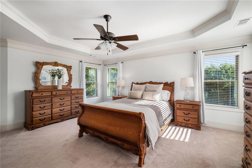 6660 Tulip Plantation Road Alpharetta, GA 30004 - Photo 26 of 68 a bedroom with a bed a dresser and a window