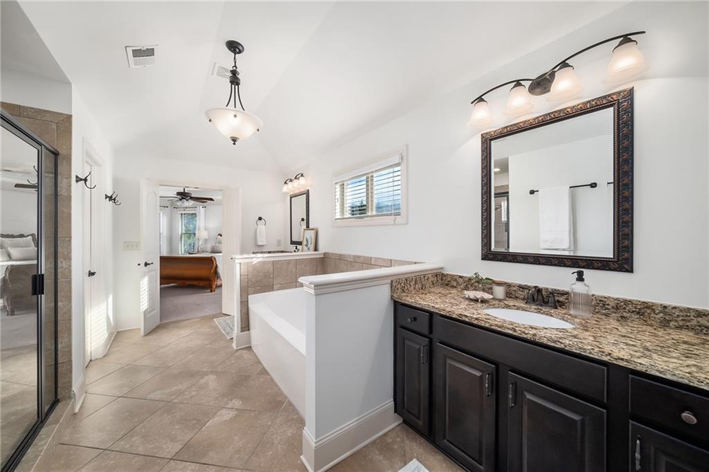 6660 Tulip Plantation Road Alpharetta, GA 30004 - Photo 30 of 68 a bathroom with a sink vanity and a mirror