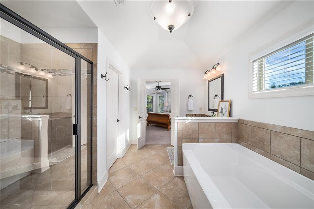 6660 Tulip Plantation Road Alpharetta, GA 30004 - Photo 31 of 68 a bathroom with a tub a sink and a mirror