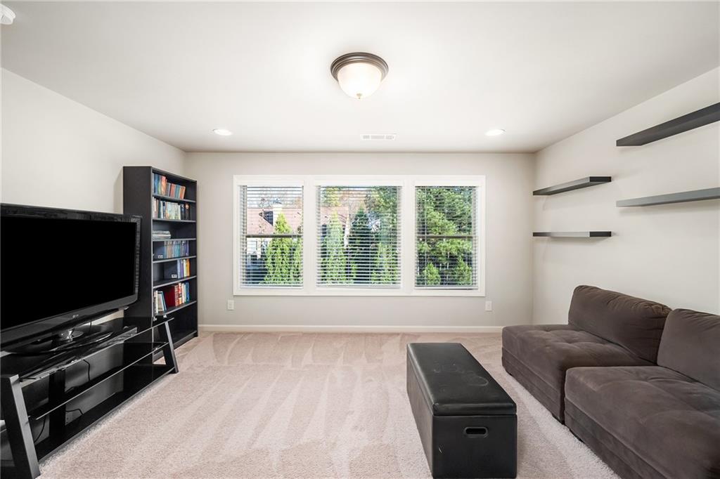 6660 Tulip Plantation Road Alpharetta, GA 30004 - Photo 32 of 68 a living room with furniture and a flat screen tv
