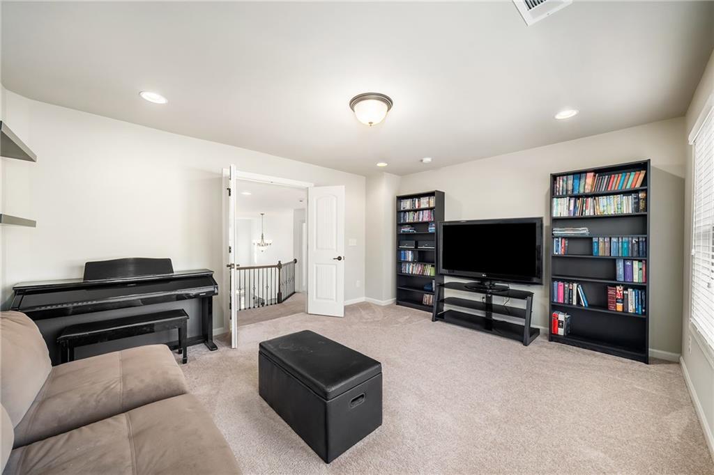 6660 Tulip Plantation Road Alpharetta, GA 30004 - Photo 33 of 68 a living room with furniture and a flat screen tv