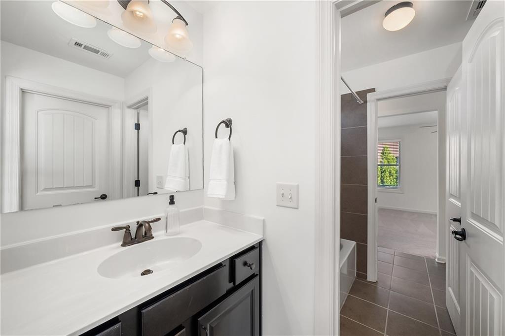 6660 Tulip Plantation Road Alpharetta, GA 30004 - Photo 35 of 68 a bathroom with a sink and a mirror