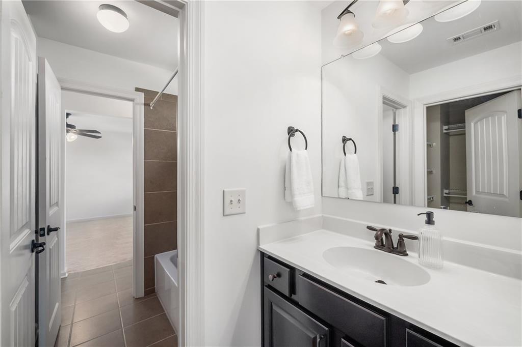6660 Tulip Plantation Road Alpharetta, GA 30004 - Photo 36 of 68 a bathroom with a sink a mirror and a shower