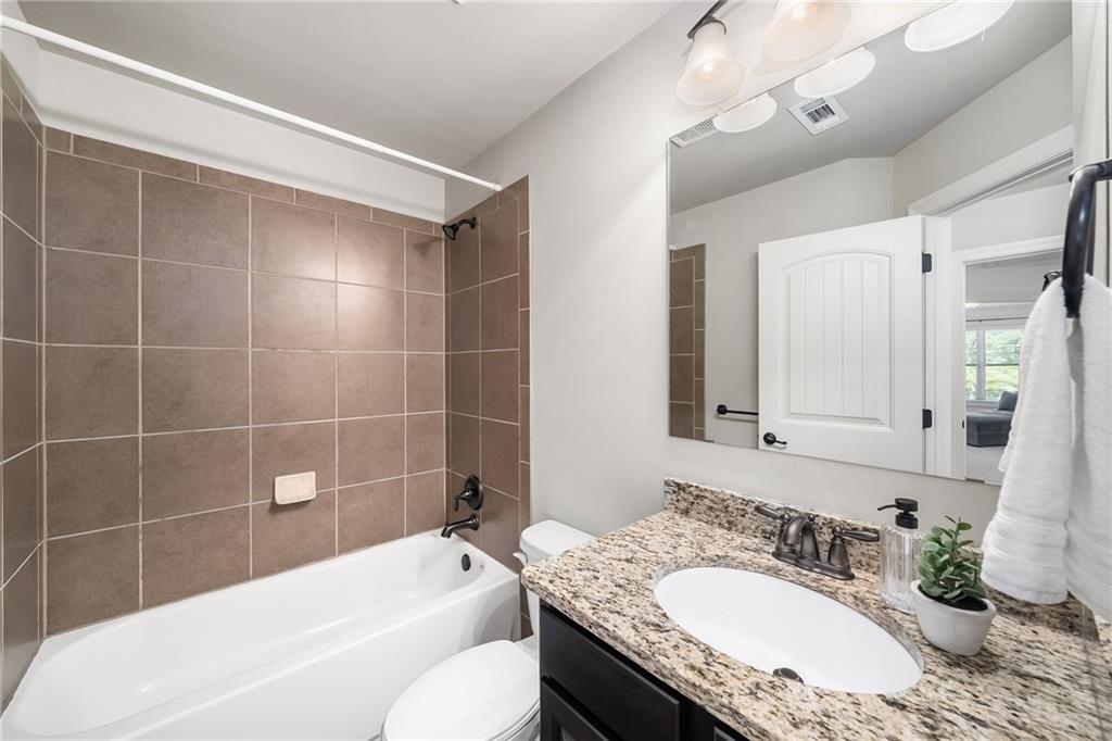 6660 Tulip Plantation Road Alpharetta, GA 30004 - Photo 38 of 68 a bathroom with a granite countertop sink a toilet and bathtub