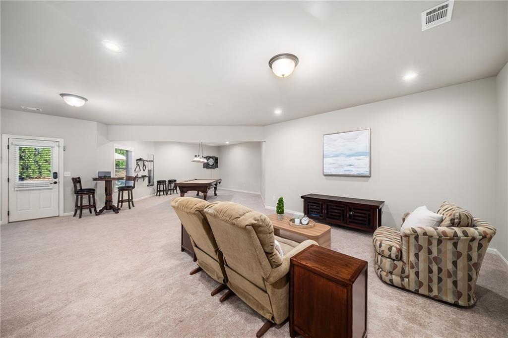 6660 Tulip Plantation Road Alpharetta, GA 30004 - Photo 40 of 68 a living room with furniture and a flat screen tv