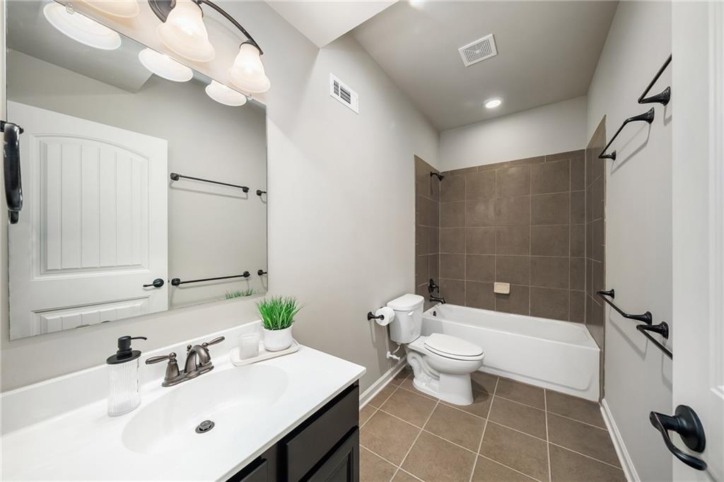 6660 Tulip Plantation Road Alpharetta, GA 30004 - Photo 47 of 68 a bathroom with a sink a toilet a mirror and shower