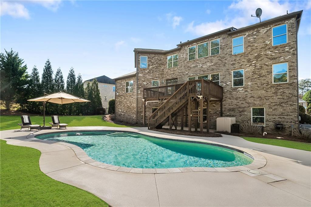 6660 Tulip Plantation Road Alpharetta, GA 30004 - Photo 49 of 68 a view of a house with swimming pool and sitting area