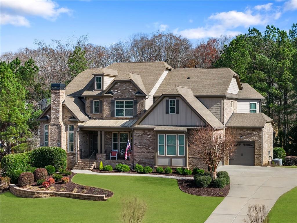 6660 Tulip Plantation Road Alpharetta, GA 30004 - Photo 53 of 68 a front view of a house with a yard table and chairs