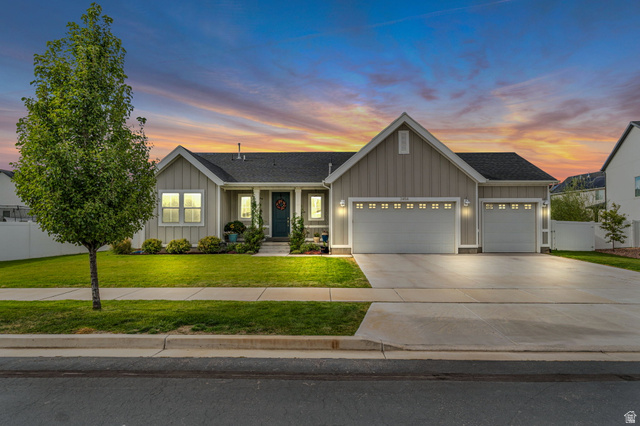 2454 West Jackson Street Mapleton, UT 84664 - Photo 62 of 63 View of front facade with board and batten siding, a garage, concrete driveway, and a shingled roof