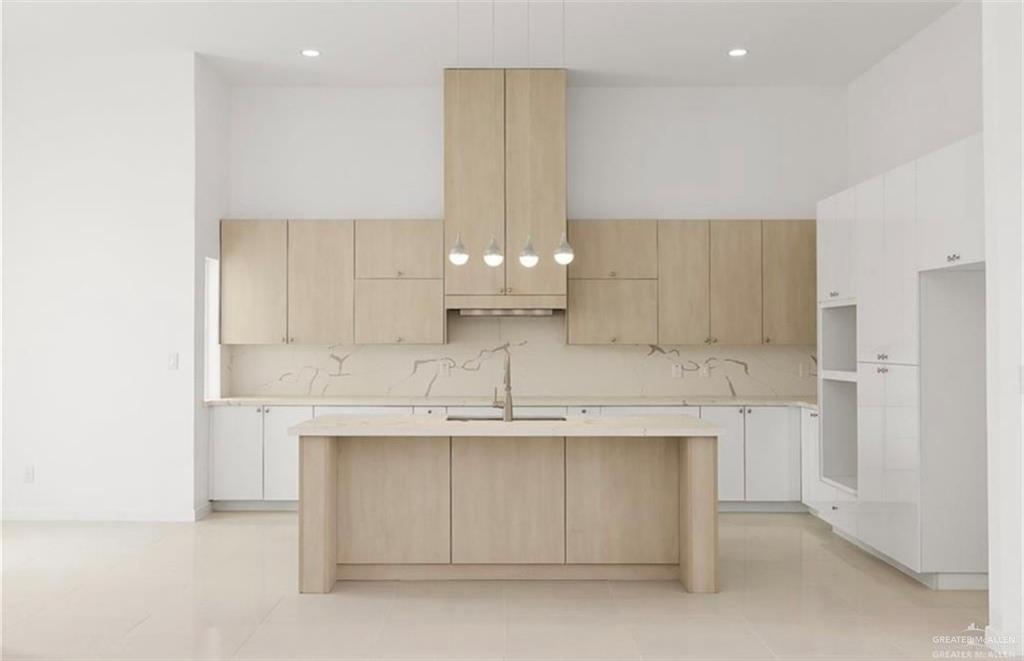 1912 East Ridgeway Circle Edinburg, TX 78542 - Photo 4 of 10 a kitchen with kitchen island cabinets and a sink