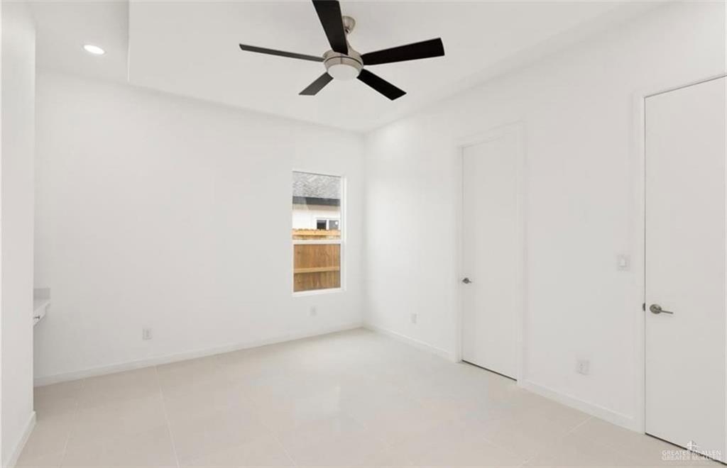 1912 East Ridgeway Circle Edinburg, TX 78542 - Photo 6 of 10 an empty room with a window and a fan