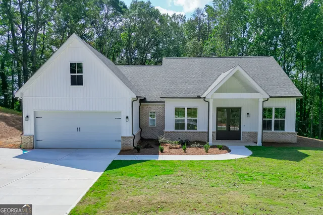 a front view of house with yard outdoor seating and green space