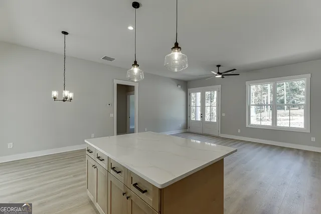 a view of kitchen with stainless steel appliances refrigerator oven microwave and stove