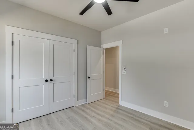 a spacious bathroom with a double vanity sink a toilet and a shower