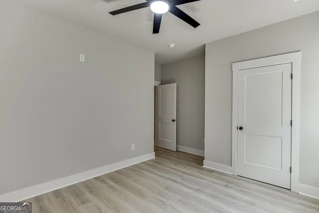 a view of a room with wooden floor