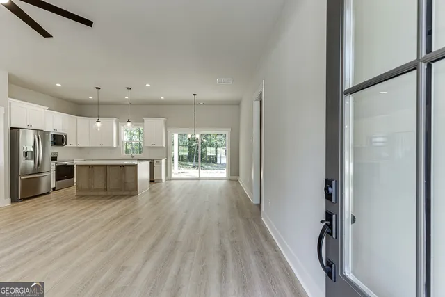 a view of kitchen with cabinets and stainless steel appliances