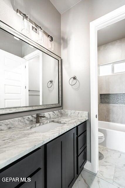 7353 Cimarron Rim Road El Paso, TX 79911 - Photo 23 of 30 a bathroom with a granite countertop sink a toilet and a mirror