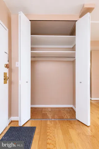 a bathroom with a granite countertop sink a toilet a mirror and shower