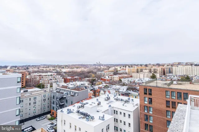 a terrace with outdoor seating and city view
