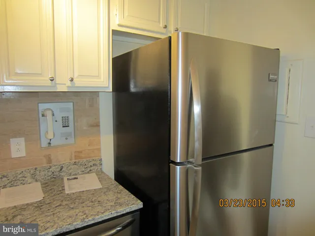 a bathroom with a granite countertop shower and a sink