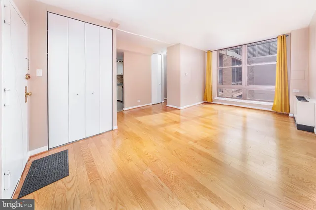 a view of an empty room with wooden floor