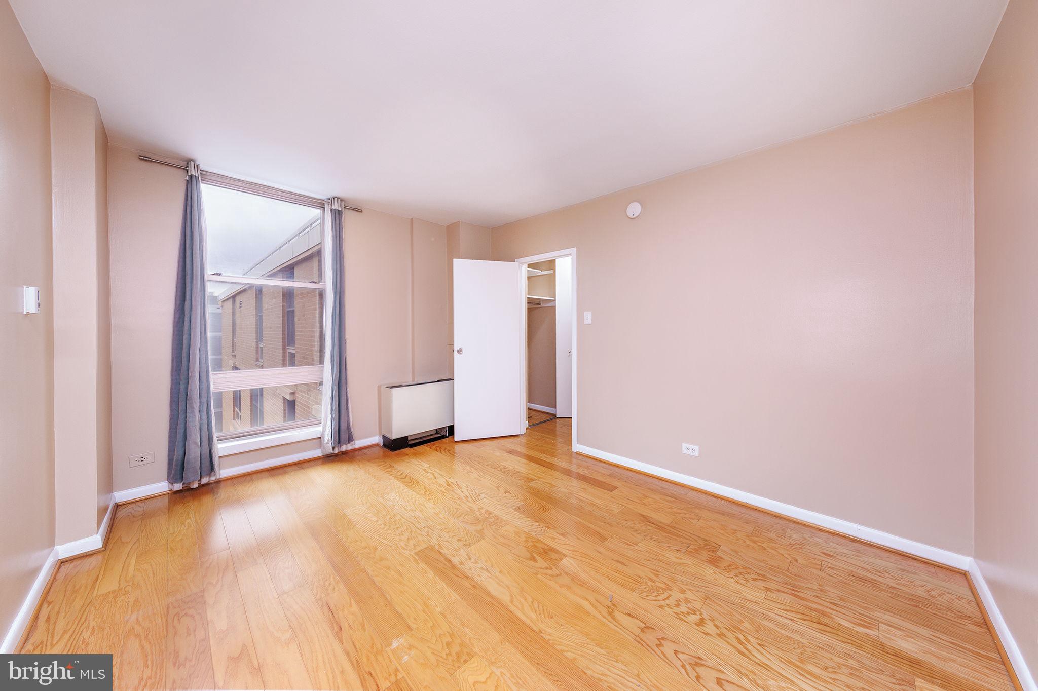 1260 21st Street Northwest, Unit 1004 Washington, DC 20036 - Photo 5 of 27 a view of an empty room with a window