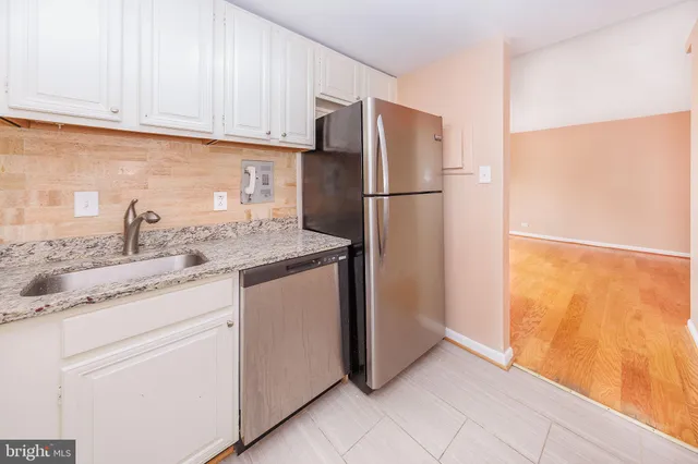 a kitchen with appliances cabinets and a counter top space