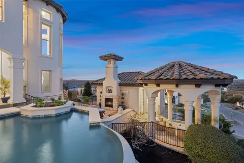 a view of a house with pool and chairs