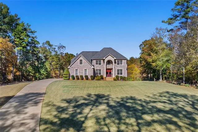 a front view of a house with a yard