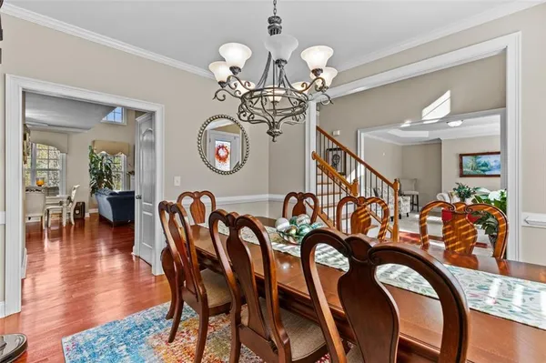 a view of a dining room with furniture wooden floor and chandelier