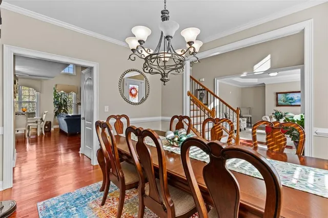 a view of a dining room with furniture wooden floor and chandelier