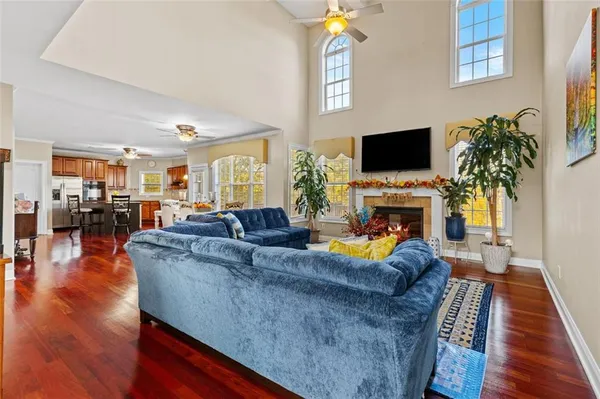 a living room with furniture dining table and a flat screen tv