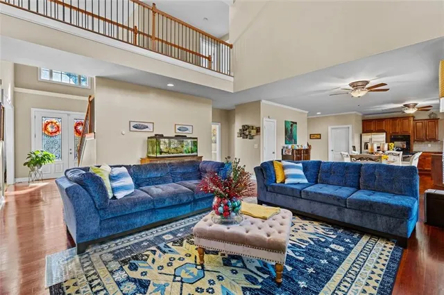 a kitchen with stainless steel appliances granite countertop a stove a sink dishwasher a dining table and chairs with wooden floor