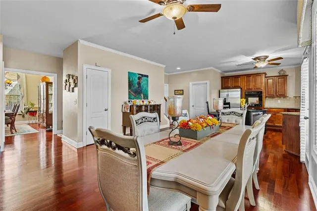 a bedroom with a bed a couch and a flat tv screen on the dresser