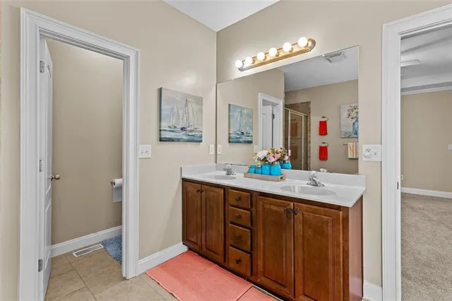 a bathroom with a sink a toilet and a mirror